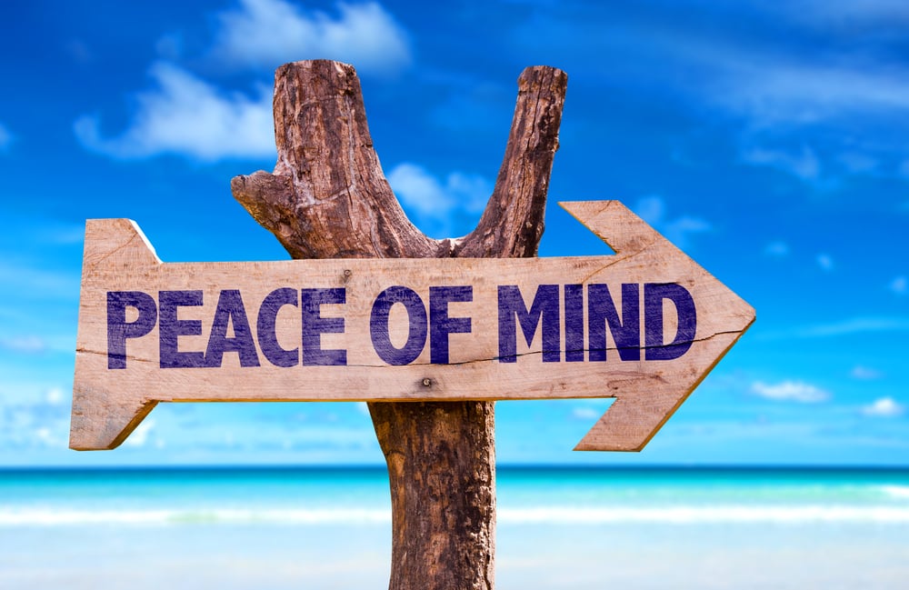 Peace of Mind wooden sign with beach background
